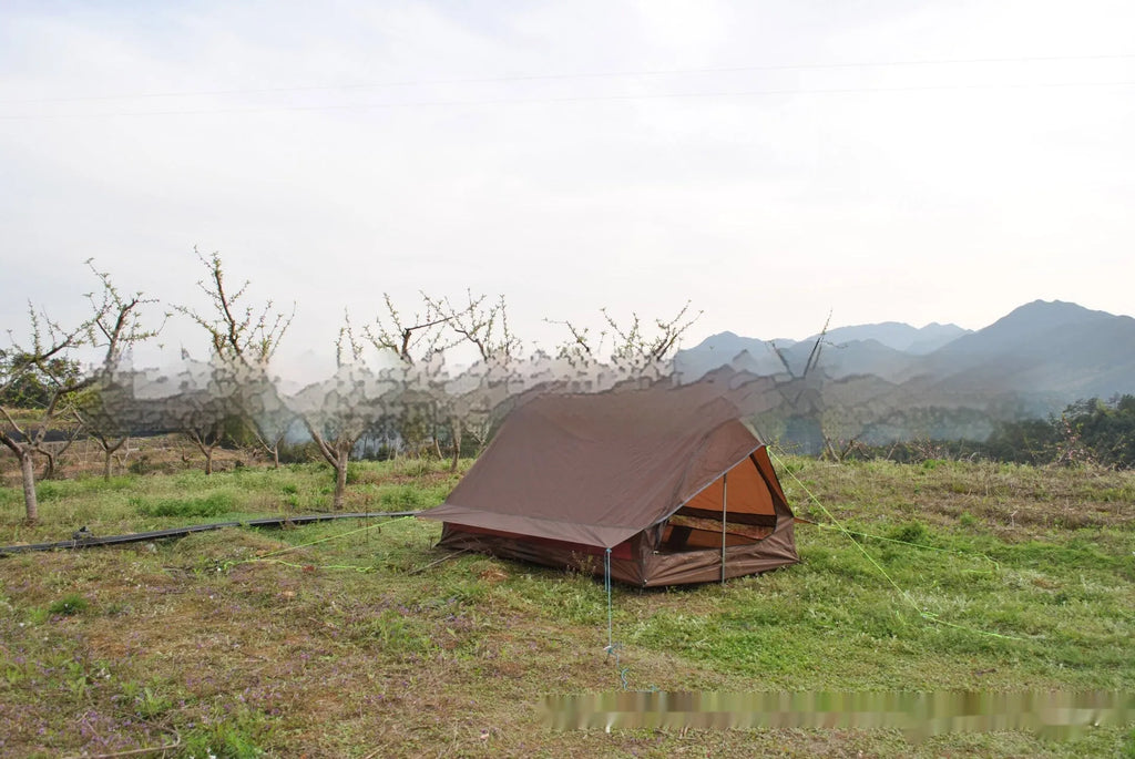 Brown A-line pole-free tent erected with hiking canes showing 2-3 person capacity and waterproof fabric construction