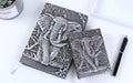 PU leather embossed retro notebook with Bronze relief cover showing beige inner pages