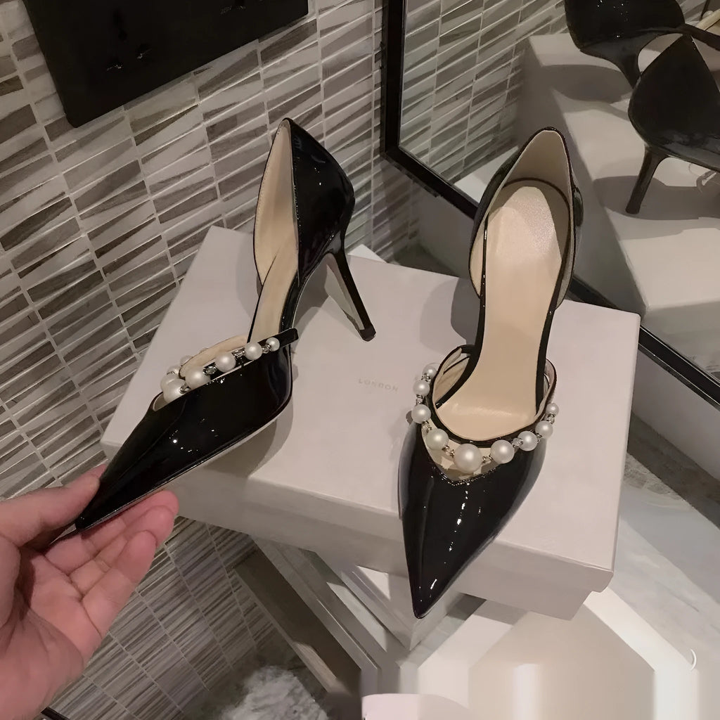 Women's pointed patent leather stiletto high heels with pearl decoration, shown in an oversleeve design.
