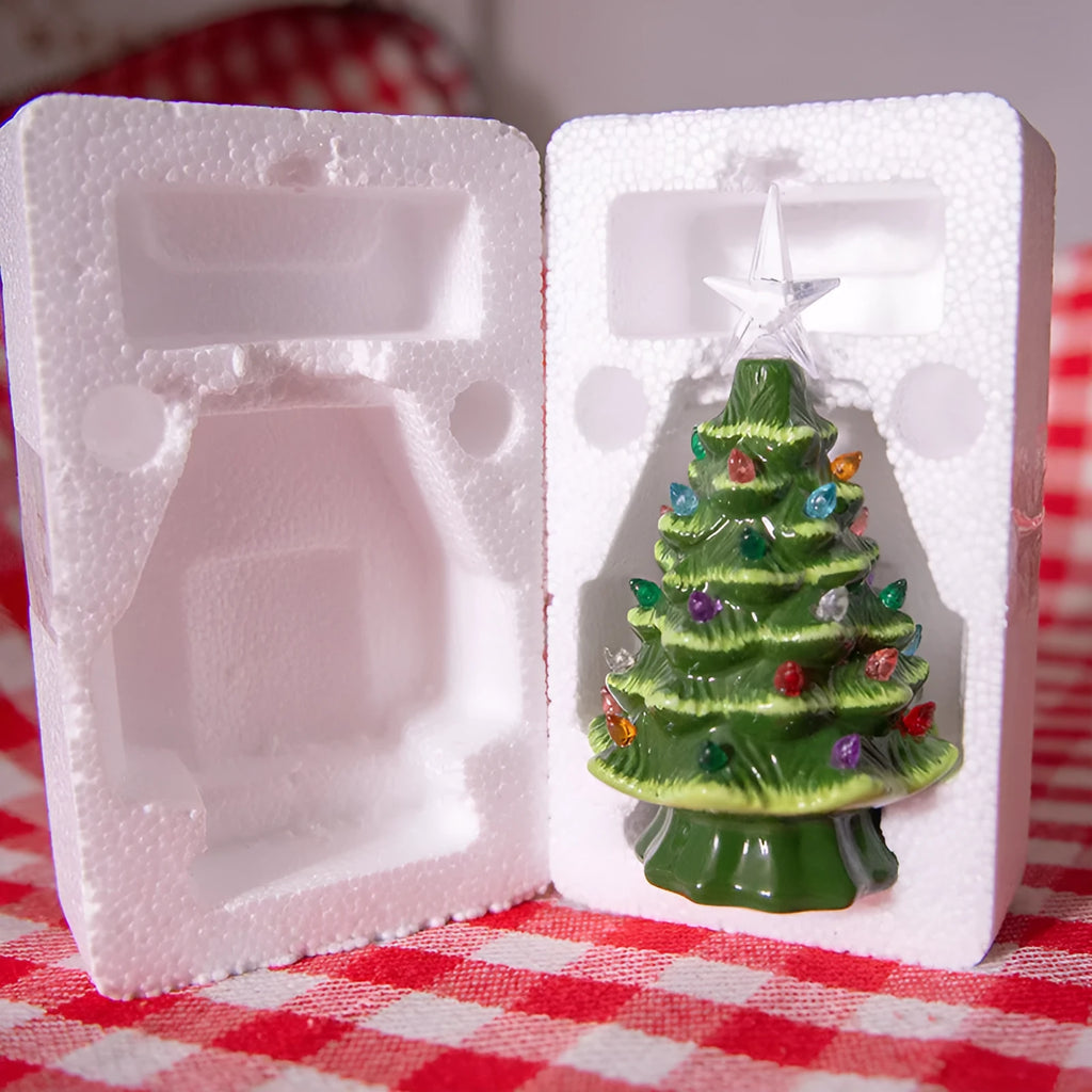 Modern simple white pottery LED Christmas tree ornament with green or white finish on a tabletop