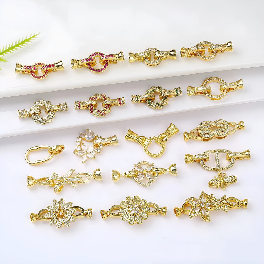 Small gold-plated necklace chain buckle on a white background, a DIY jewellery finding.