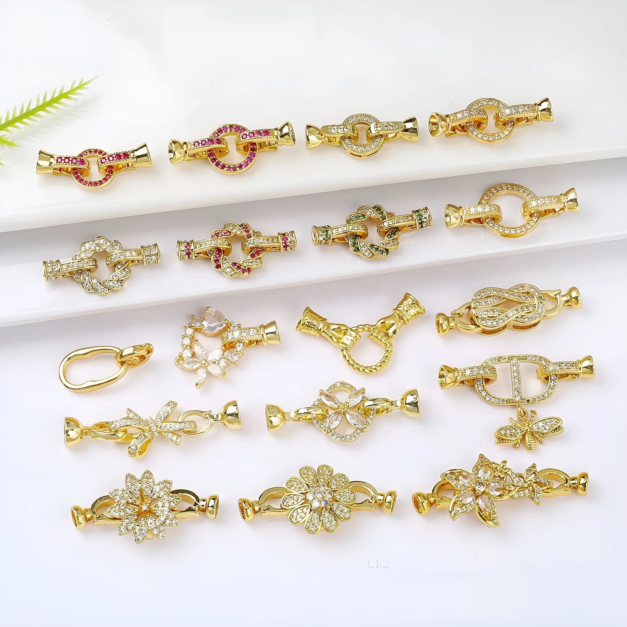 Small gold-plated necklace chain buckle on a white background, a DIY jewellery finding.