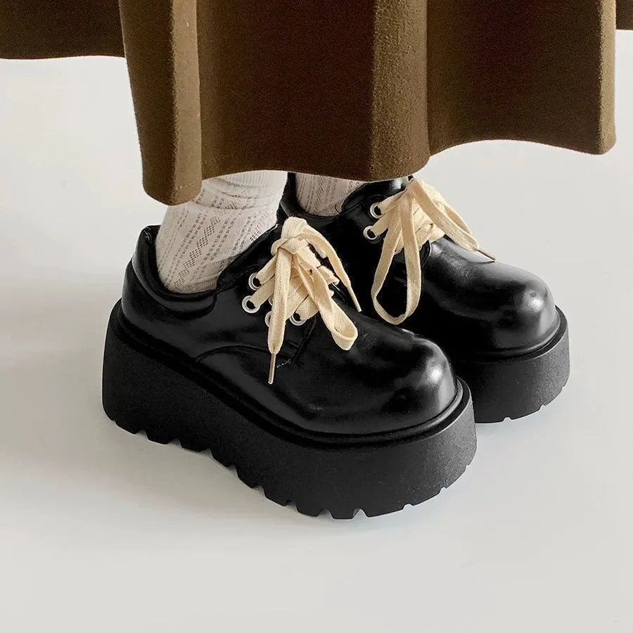Women's black matte PU leather chunky platform shoes with lace-up buckle and round toe.