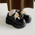 Women's black matte PU leather chunky platform shoes with lace-up buckle and round toe.