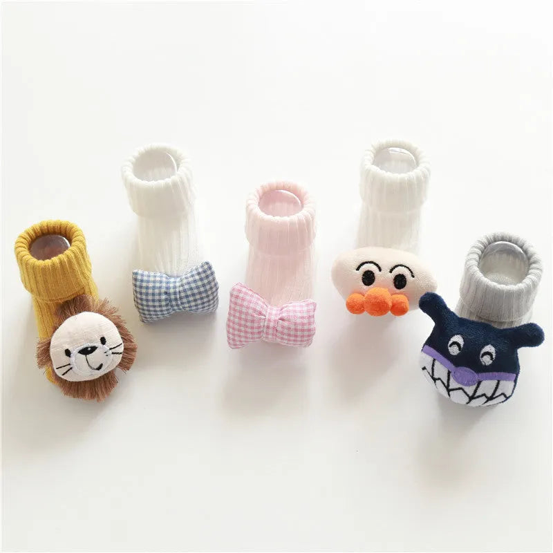 Cotton baby socks with non-slip soles in multiple designs including bows, stars, and animal prints.