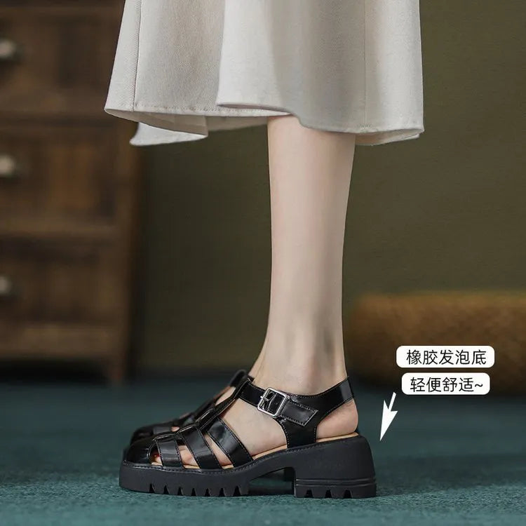 Women's black retro platform sandals with closed toe, hollow sides, chunky heel, and a buckle fastening.