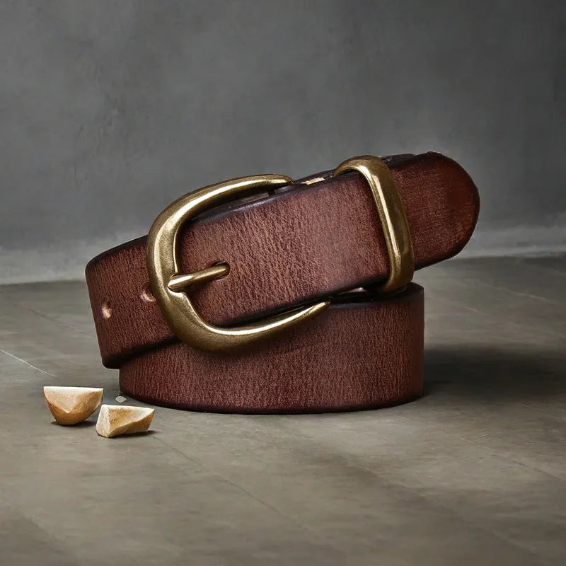 Men's casual leather belt in black with a copper pin buckle on a jeans background