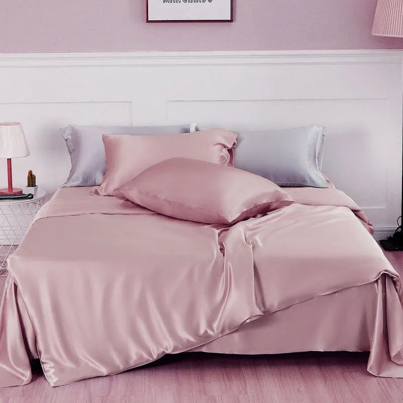 Double-sided silk duvet cover in plain weave, shown in one of six solid colours, laid flat on a bed.