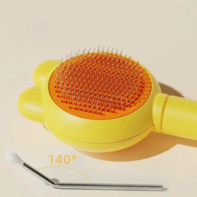 Self-cleaning pet brush with green handle and stainless steel teeth, showing release button mechanism