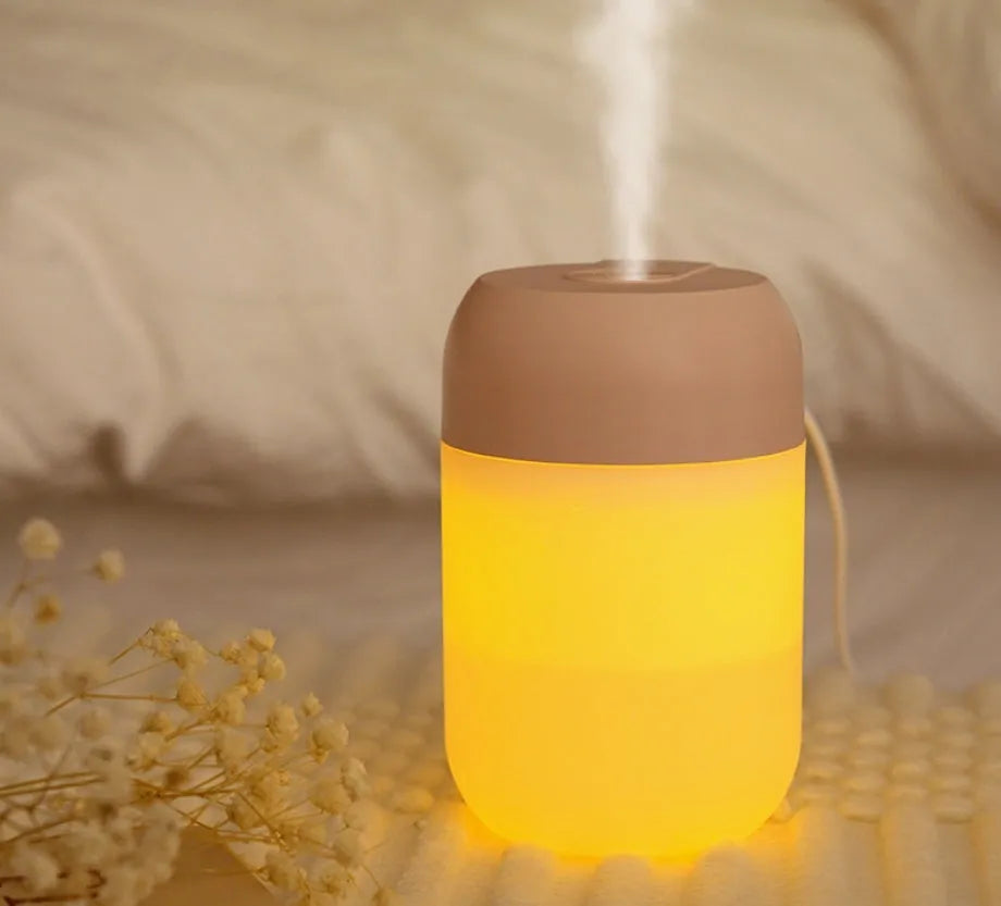 Small white cylindrical USB-powered humidifier for silent bedroom and desk use.