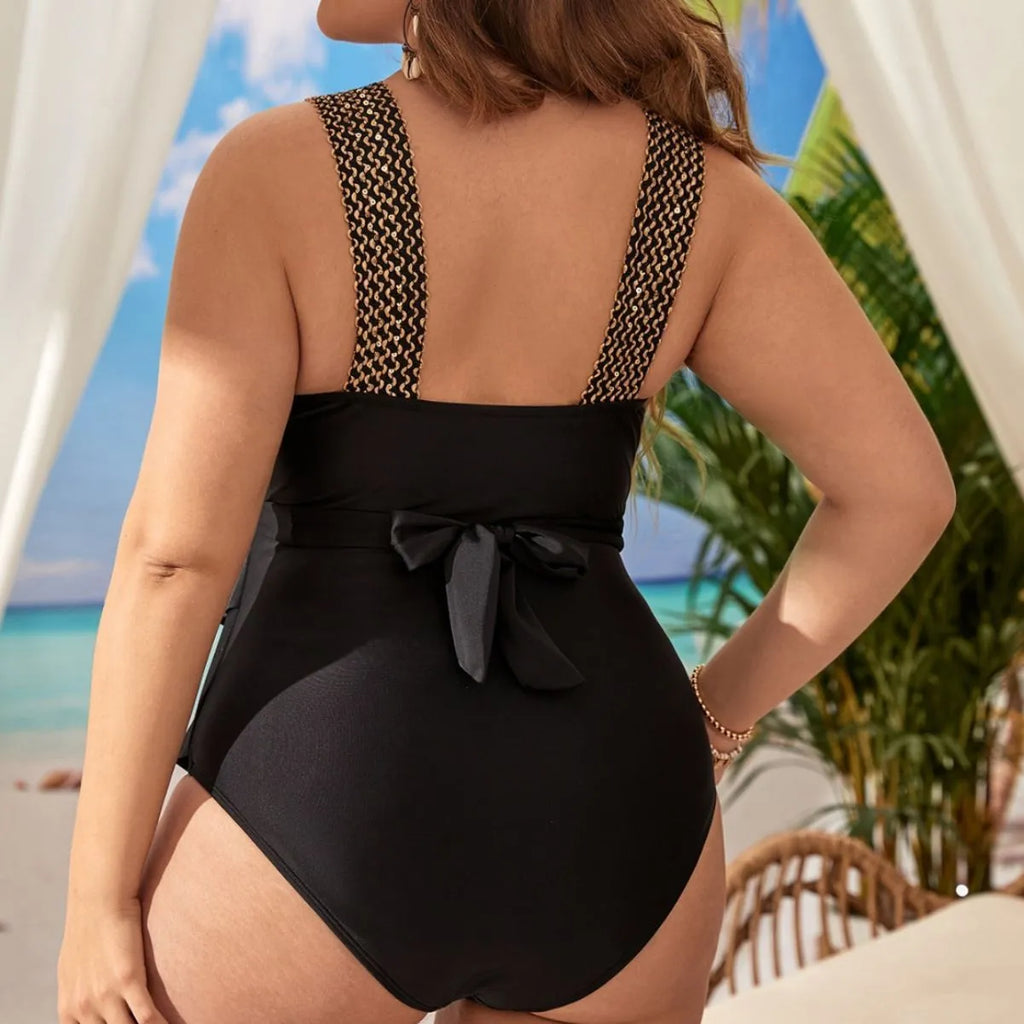 Women's black one-piece sleeveless swimsuit with chest pad support on a mannequin.