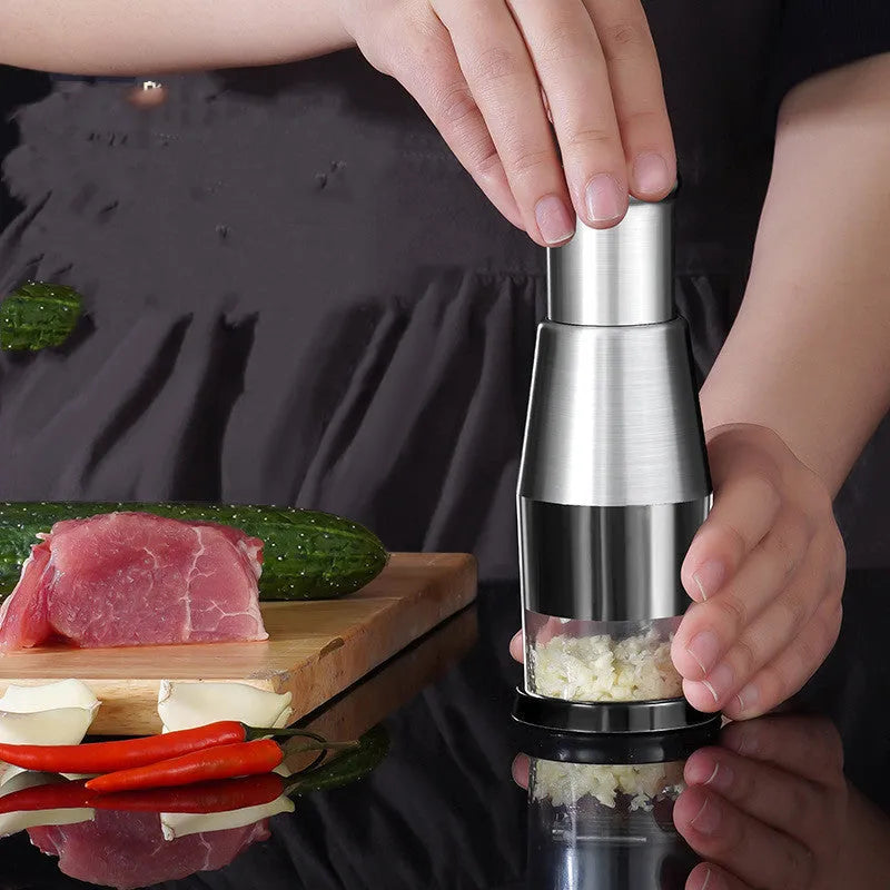 Black manual garlic press with stainless steel blades for chopping vegetables and onions
