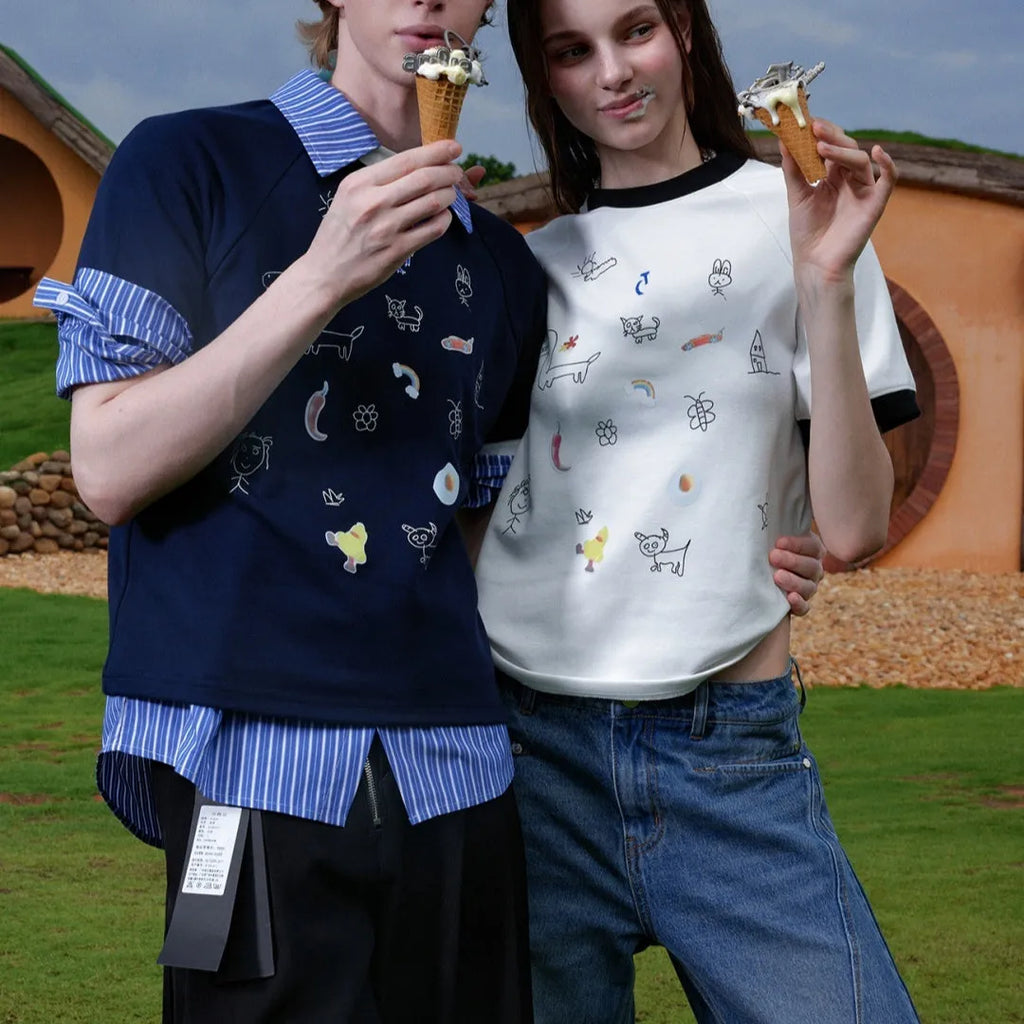 Men's blue short-sleeved shirt with cartoon print, loose fit, and contrasting colour panels.
