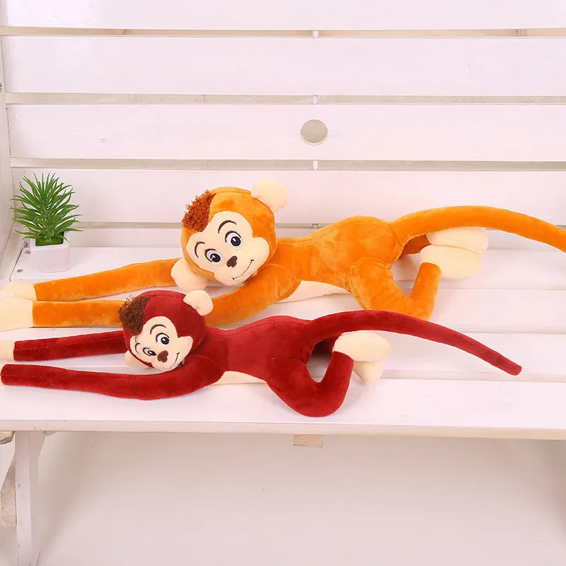 Long-armed pink plush monkey toy hanging from a curtain rod