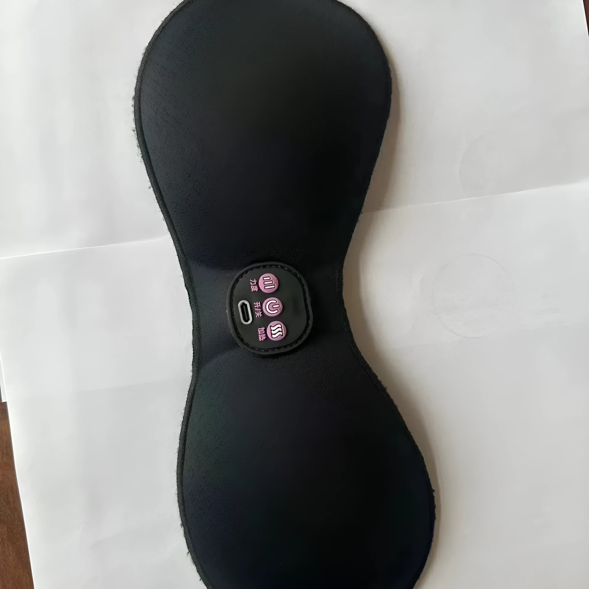 Black electric massage chest pads with adhesive stickers and three-button control panel