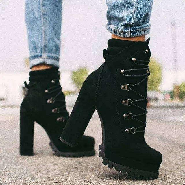 Women's suede high heel Roman ankle boots with round toe, thick heel, and buckle detail in four colours.