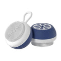 Yellow silicone pet bath brush with massage head and comb, shown next to a bottle of pet shampoo.