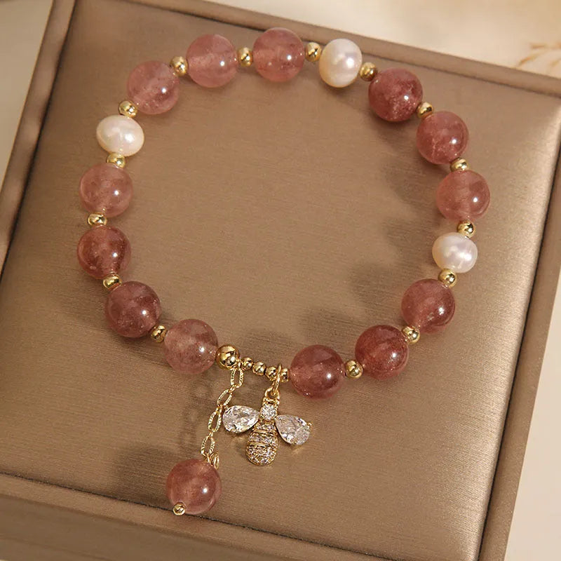 Women's bracelet with strawberry quartz beads, freshwater pearls, and zircon accents on an alloy setting.