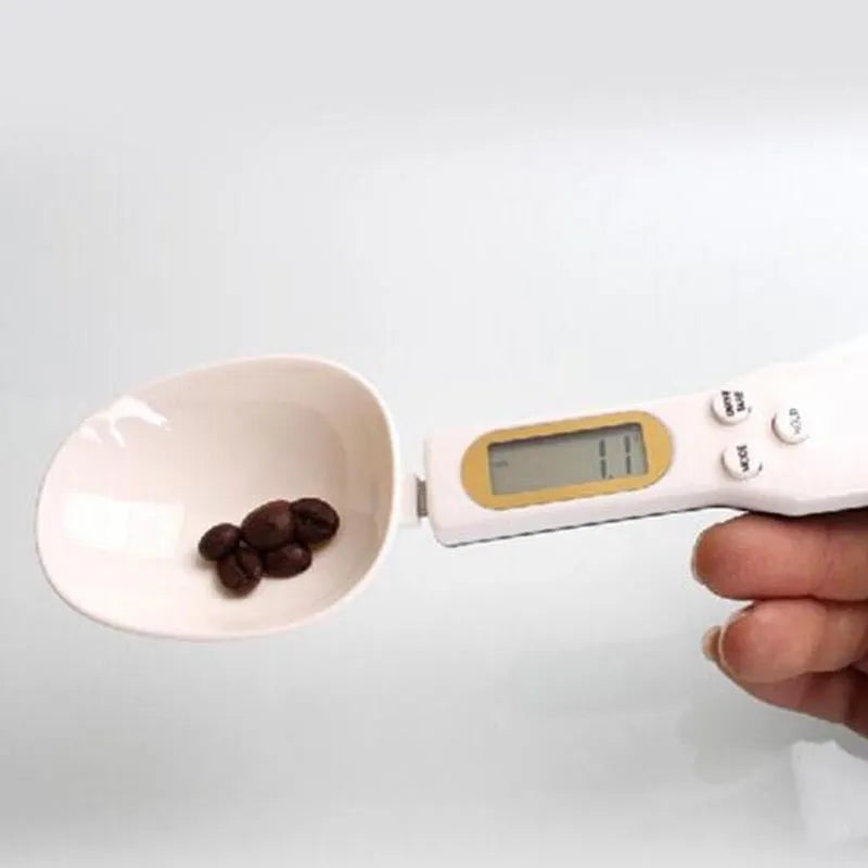 White digital spoon scale with LCD display showing weight measurement for kitchen use