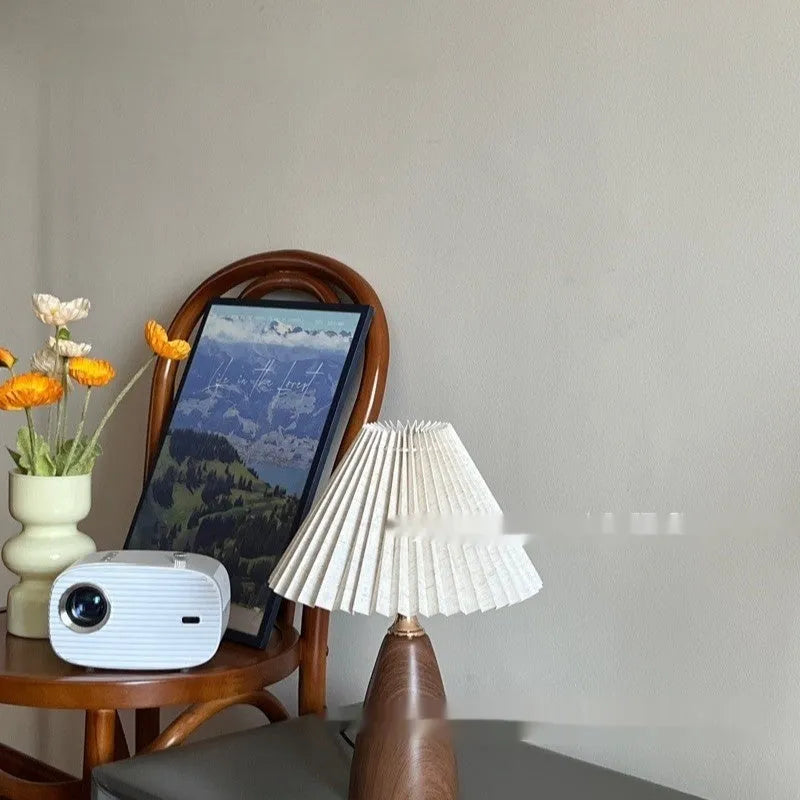 Nordic style ceramic table lamp with a pleated fabric shade on a bedside table