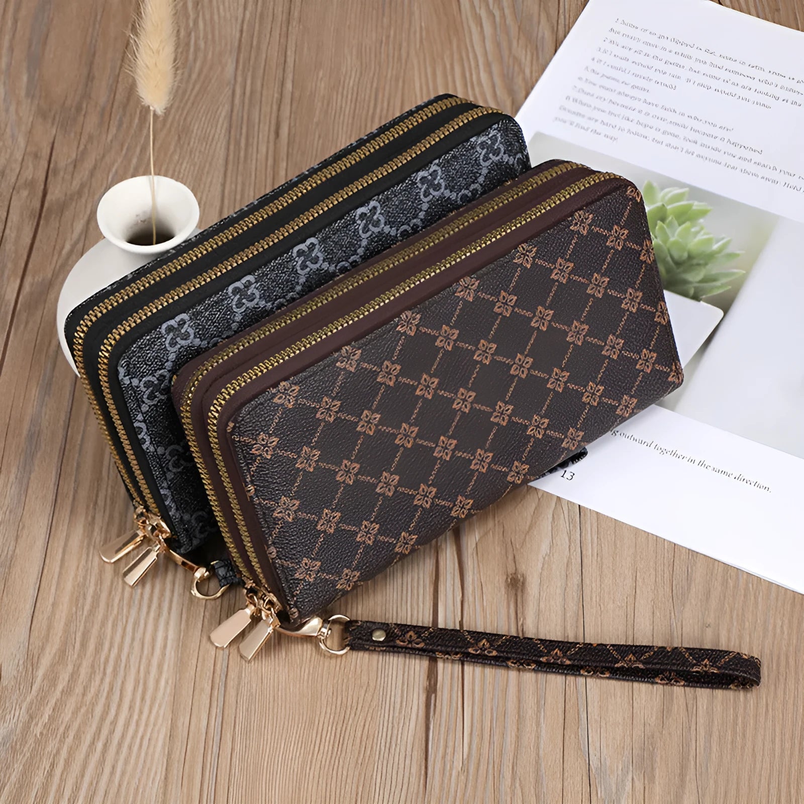 Black retro print long wallet clutch bag with zipper, holding a mobile phone and cards.