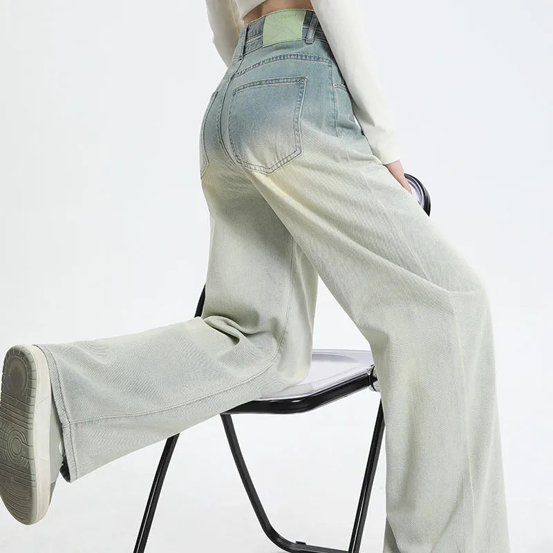 Gradient blue straight-leg women's jeans on a neutral background showing the colour transition.