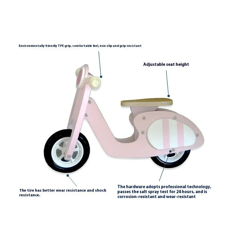 Pink wooden balance scooter for toddlers, 10 inches in size, on a flat surface.