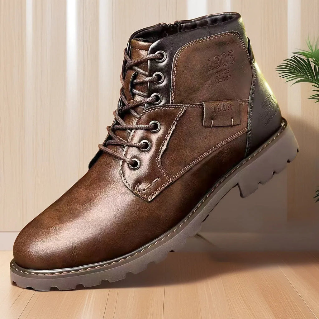 Men's brown leather-style ankle boot with a side zip and round toe on a rubber sole.