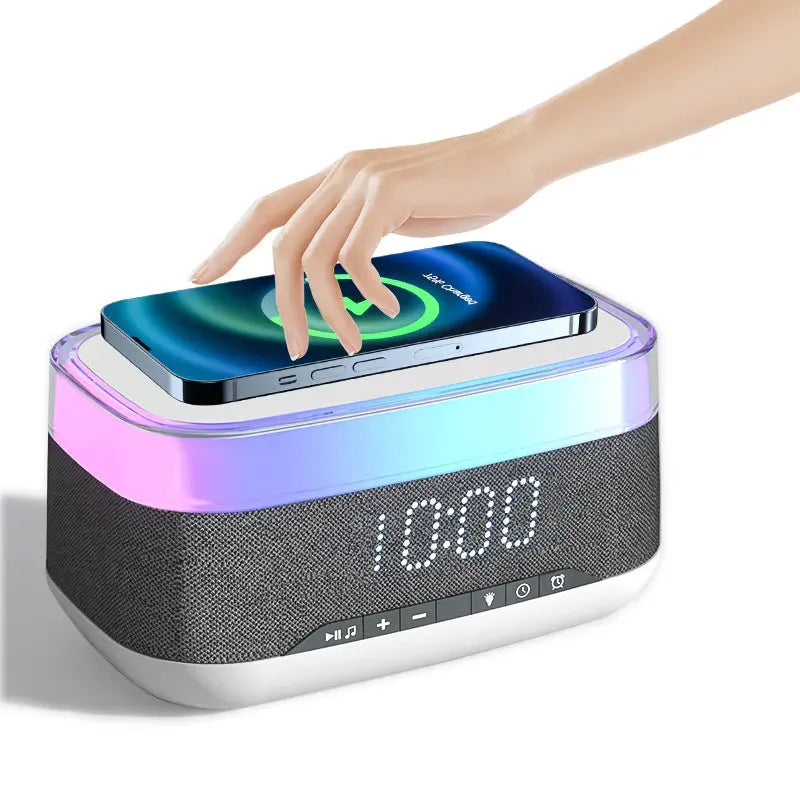 White multifunctional alarm clock with Bluetooth speaker and wireless charging pad on a table