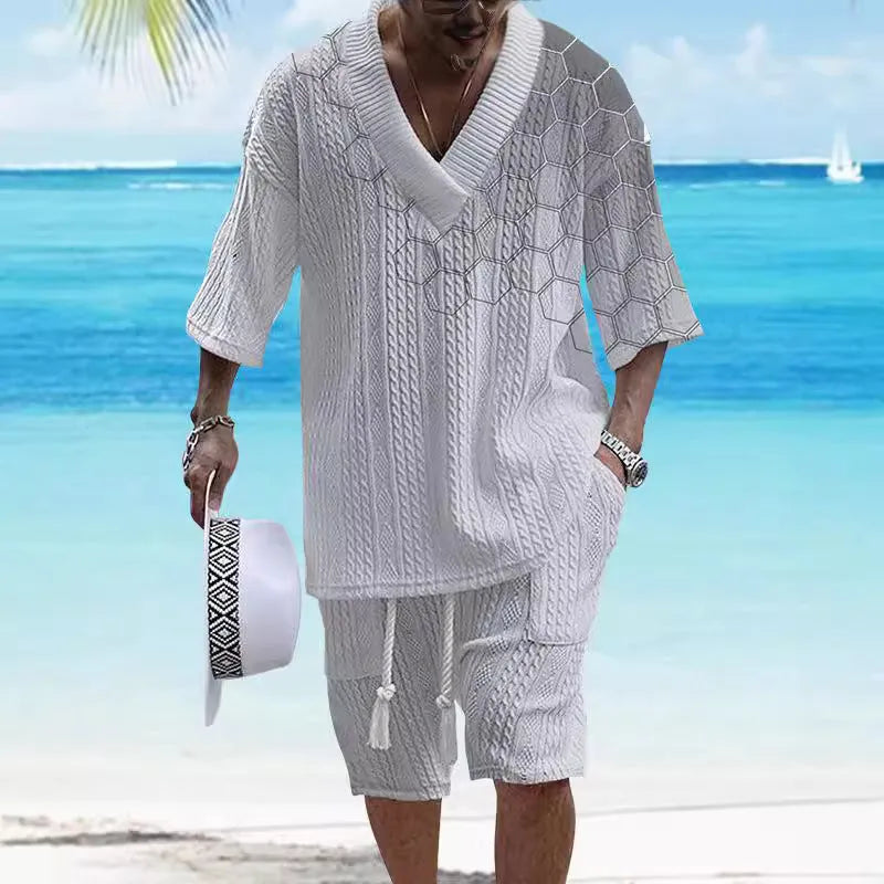 Man wearing a printed drop-shoulder knitted top and matching shorts from a casual summer suit.