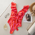 Women's one-piece swimsuit with ruffled straps, deep V-neck, and mesh stitching in a printing colour pattern.