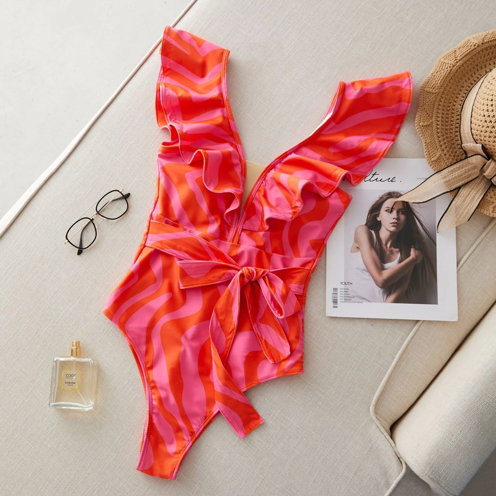 Women's one-piece swimsuit with ruffled straps, deep V-neck, and mesh stitching in a printing colour pattern.