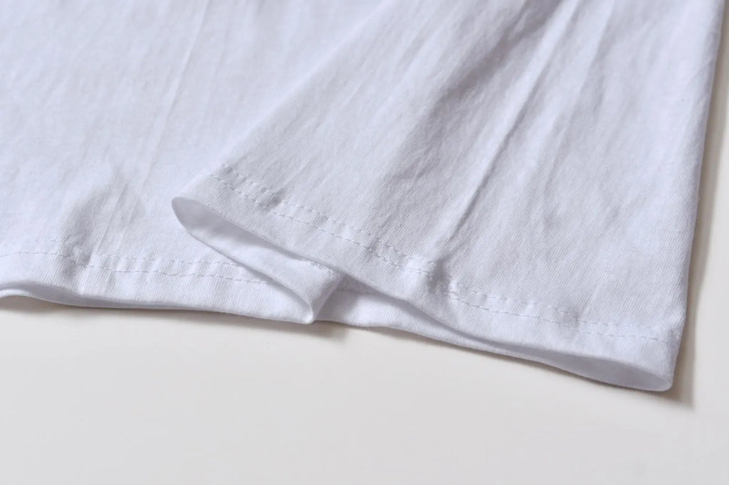 White cotton denim overalls with round neck and short sleeves, loose fit pullover style