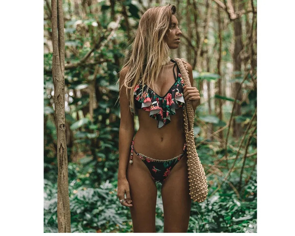 Black bohemian leaf print split bikini swimsuit with chest pad on display