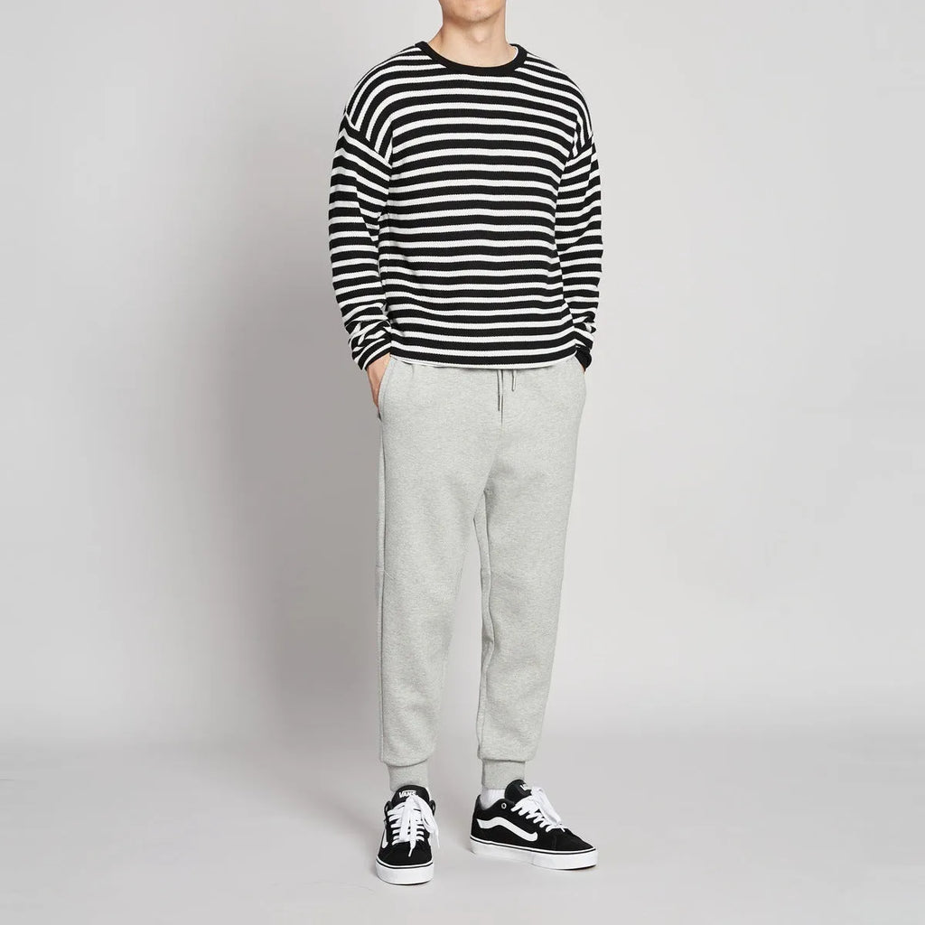 Men's mid-waist drawstring casual pants in black cotton blend, loose nine-length fit.