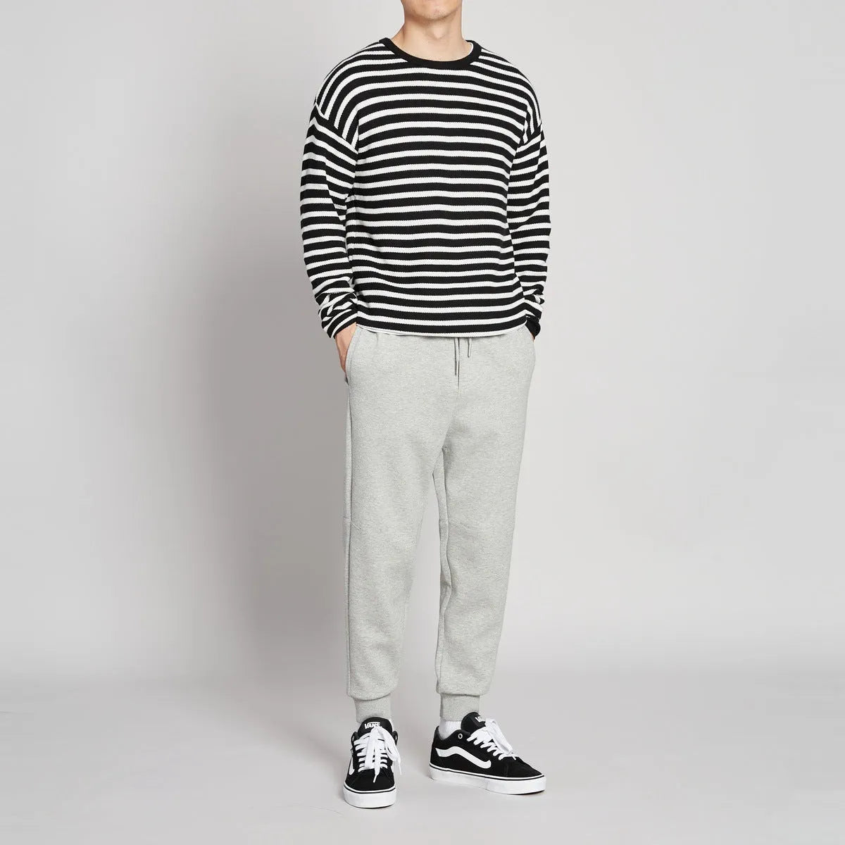 Men's mid-waist drawstring casual pants in black cotton blend, loose nine-length fit.