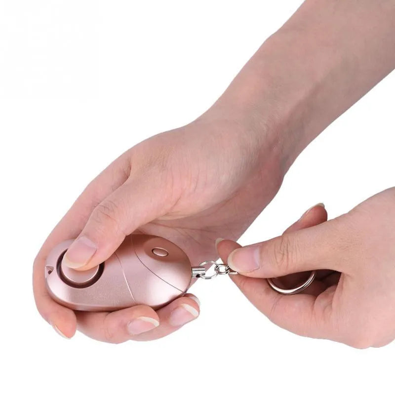 Personal alarm keychain with 130dB sound and LED flashlight in pink colour