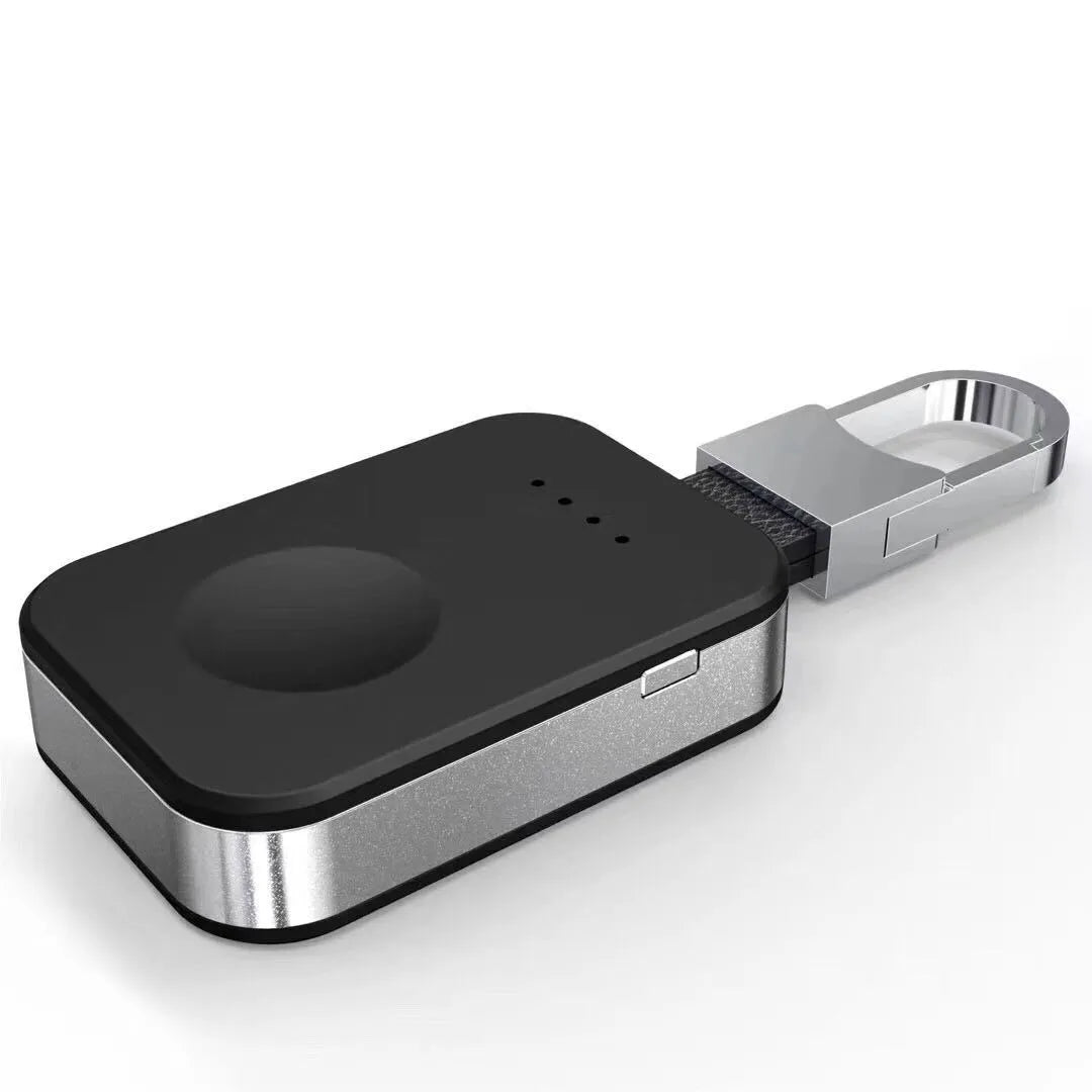 Black portable keychain power bank for wireless charging of an Apple Watch.