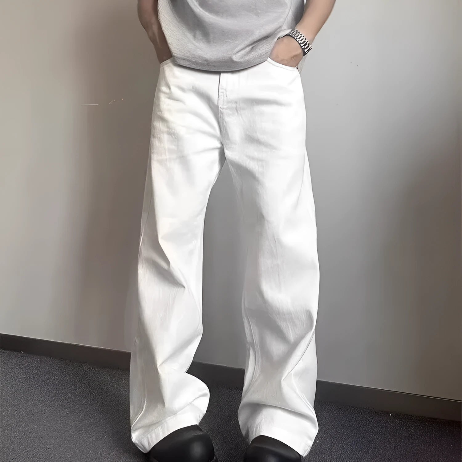 Men's loose straight wide leg white cotton denim jeans on a plain background