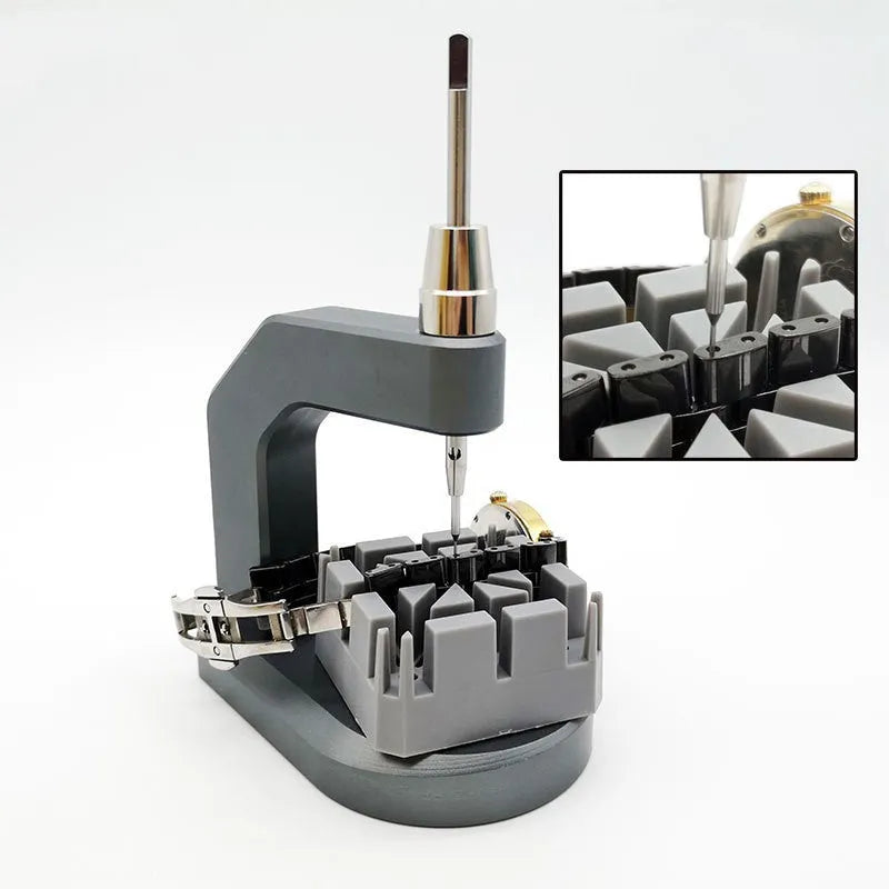 Silver tool steel multi-purpose press strap removal tool on a work surface.