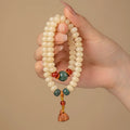 Milk butter coloured Bodhi root wooden bracelet with 6x9mm flat round beads and double ring design