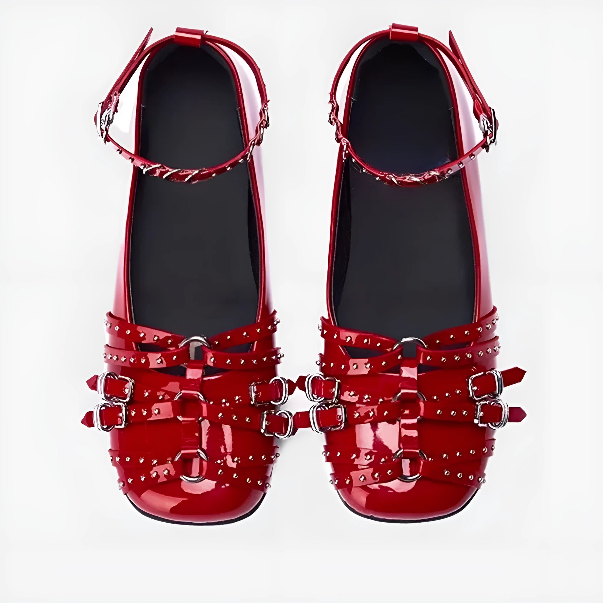Women's black patent leather buckle pumps with a square toe and low flat heel on a white background.