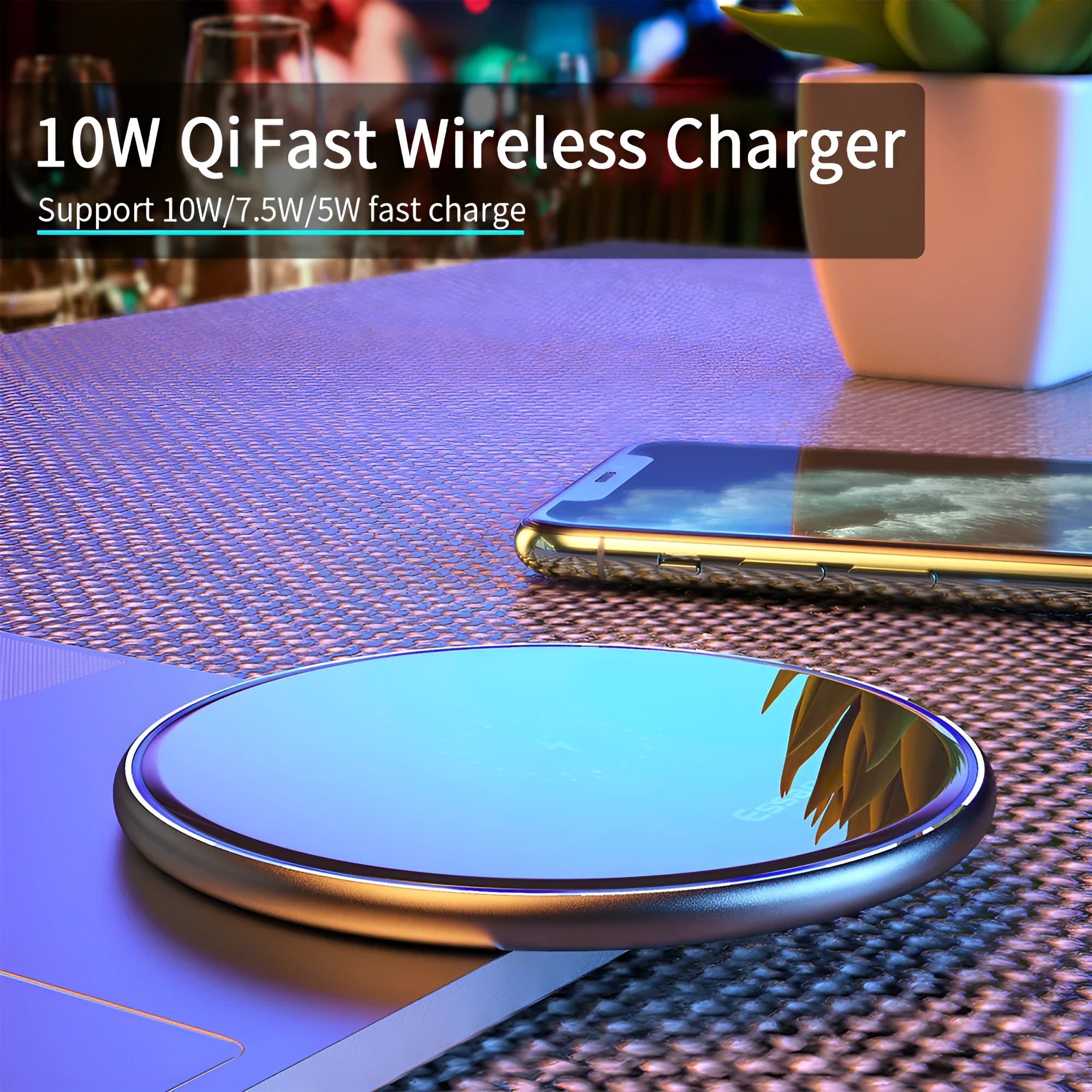Black wireless charging pad on table with phone charging and blue LED indicator light
