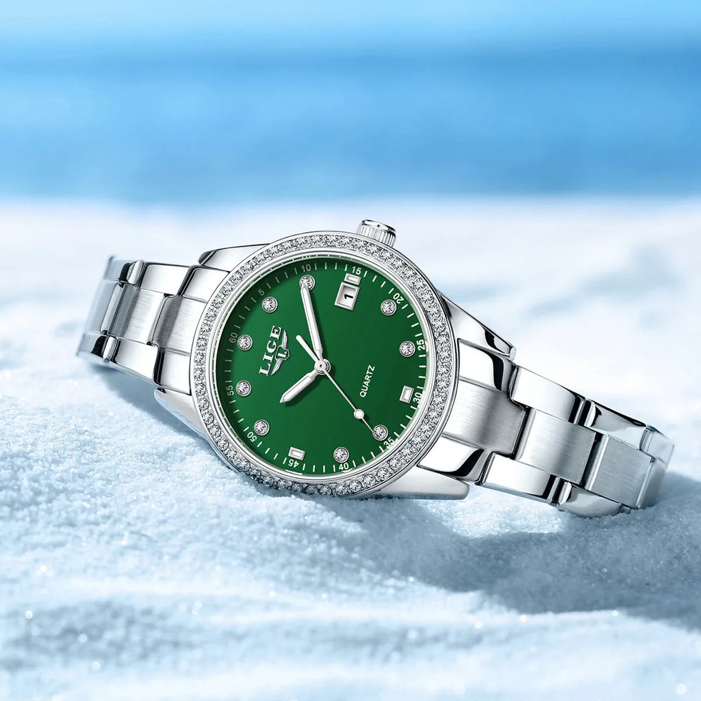 Women's silver stainless steel watch with diamond bezel and luminous hands on a 34mm round dial.