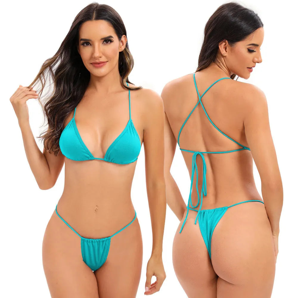 Women's candy coloured cross strap split swimsuit with multiple straps on a mannequin.