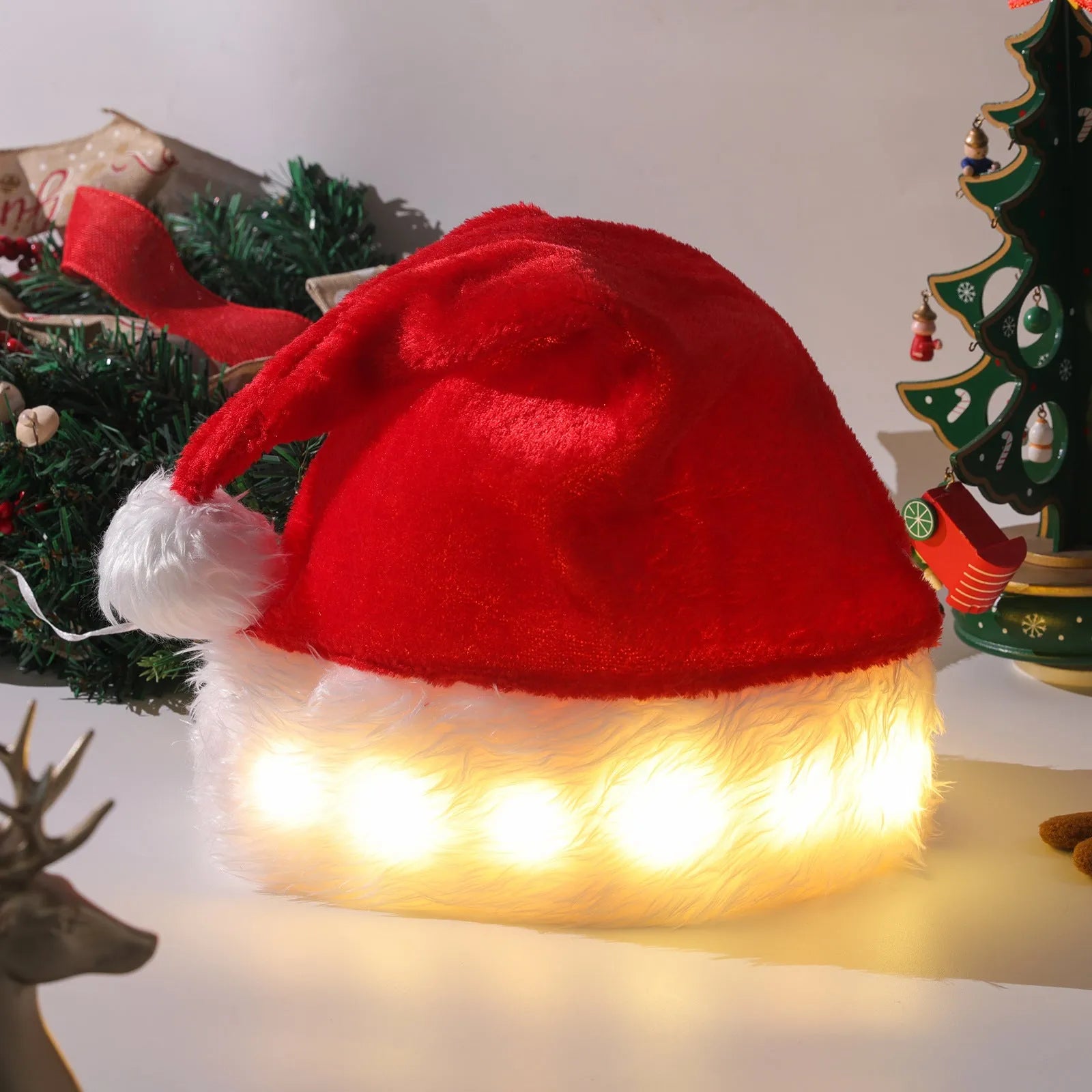 Red and white plush Santa hat with multicoloured LED lights glowing around brim and pom-pom decoration