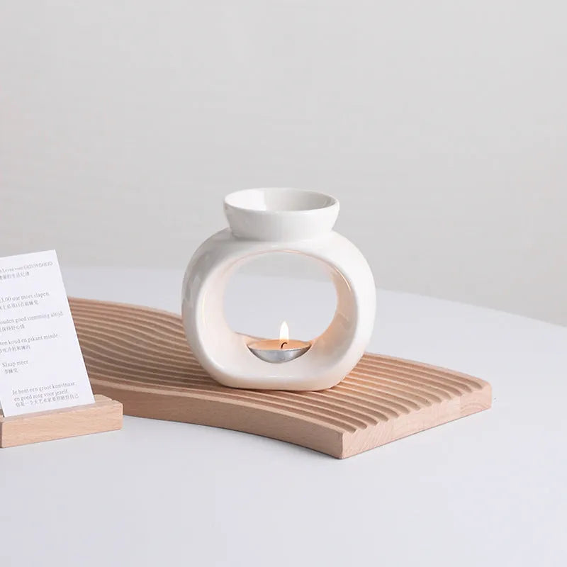 White Nordic style ceramic aromatherapy stove ornament on a wooden surface