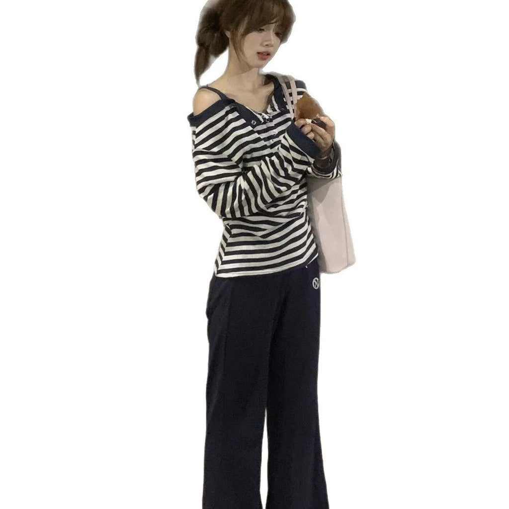 Dark blue Korean-style oversized women's long-sleeved t-shirt with stripes, buttons, and embroidery detail.