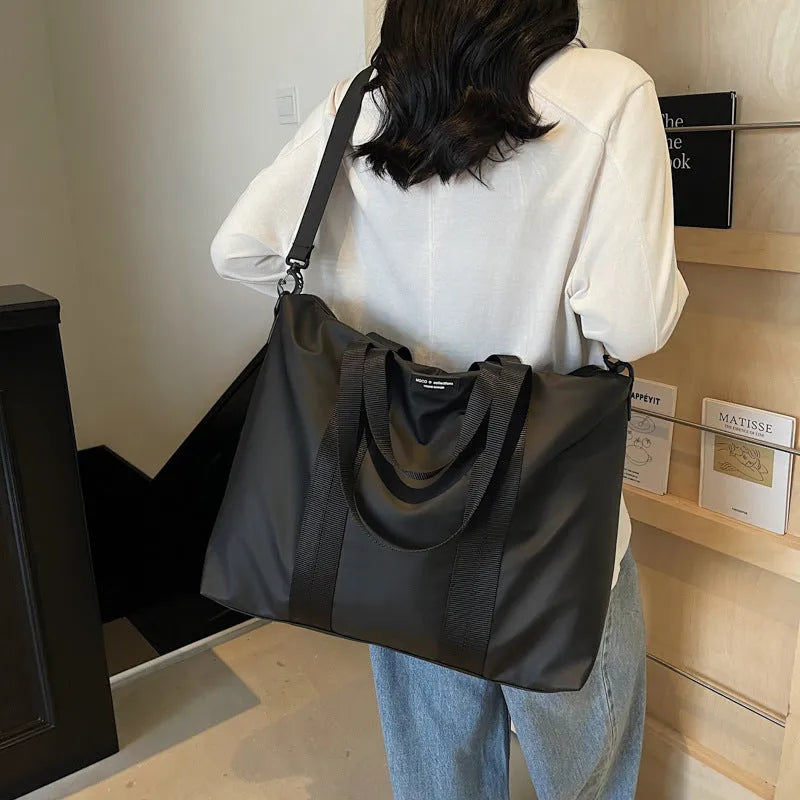 Lightweight Oxford cloth tote bag in black, grey, or champagne with 20-35L capacity for travel
