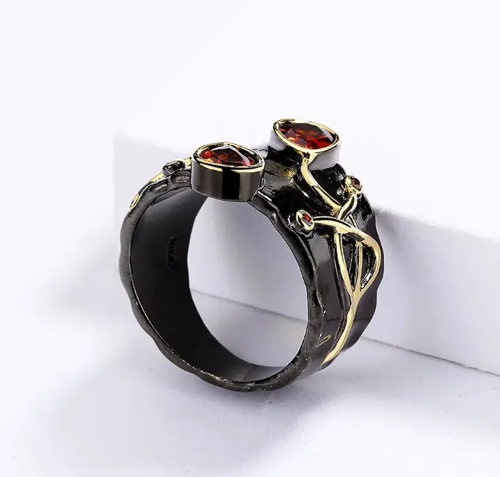Retro women's straight-pull oval ring in brass with black finish, side view on light background